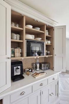 a kitchen with white cabinets and open shelves