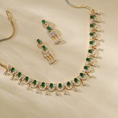 Description: This stunning necklace from our CZ collection showcases a beautiful mix of white and green CZ stones in a sophisticated design. Finished with gold plated- base, it adds a polished touch to any outfit. Whether as a gift or for special occasions, this necklace blends timeless elegance with modern style. Details & Specification: Materials used: Brass Alloy with Gold & White Gold Plating Weight - Necklace- 23 gm, Earrings- 6 gm Length - Necklace- 10 cm, Earrings- 3.5 cm Make it custom: Elegant May Birthstone Crystal Necklace, Elegant May Birthstone Crystal Necklaces, Elegant Gold Plated Stone Necklaces, Elegant Gold Plated Necklaces With Stones, Elegant Green Kundan Necklace For Anniversary, Elegant Green Round Kundan Necklace For Anniversary, Elegant Green Kundan Necklace For Formal Occasions, Elegant Gold-plated Necklaces With Stones, Green Crystal Necklace For Celebration