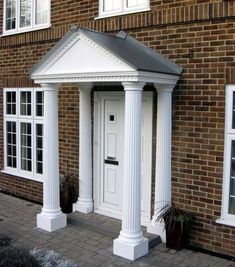 a white front door on a brick building