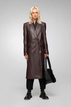 Women's Leather Trench Coat In Coffee Brown Indulge in timeless elegance with this women's leather trench coat in coffee brown. Crafted from genuine sheepskin leather with a semi-aniline finish, this long coat features a sophisticated notch collar and button closure. The stylish design is enhanced with zipper cuffs, offering a modern touch. Practicality meets luxury with one inside pocket and two side pockets. Perfect for any occasion, this coat adds a refined touch to your wardrobe. Outer Shell: Genuine Leather Leather Type: Sheepskin Leather Finish: Semi-aniline Feature: Long Coat Closure Style: Button Collar Style: Notch Cuffs Style: Zipper Inside Pockets: One Outside Pockets: Two Side Pocket Color: Coffee Brown Leather Trench Coat Woman, Leather Shorts Women, Short Leather Skirts, Leather Jumpsuit, Shearling Vest, Studded Jacket, Sheepskin Jacket, Distressed Jacket, Leather Trench