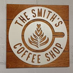 the smith coffee shop sign is mounted on a wooden plaque that says, the smith's coffee shop