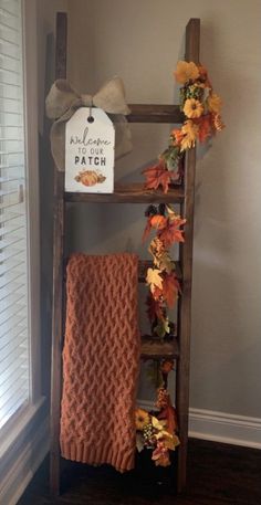 a wooden ladder with fall leaves on it