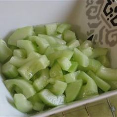 sliced up green vegetables in a white bowl