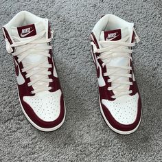 The Nike Women's Dunk High 'Burgundy Crush' Outfits The Retro Hoops Shoe In Classic Two-Tone Color Blocking, Redolent Of The Introductory 'Be True To Your School' Series From 1985. The Leather Upper Combines A White Base With Contrasting Burgundy Overlays And A Color-Matched Swoosh. A Padded High-Cut Collar, Along With A Breathable Nylon Tongue, Provides A Secure And Comfortable Fit. Anchoring The Sneaker Is A Durable Cupsole, Featuring Stitched Sidewall Construction And A Grippy Rubber Outsole. Sporty Burgundy High-top Sneakers, Burgundy Sneakers With Cushioned Footbed For Streetwear, Burgundy Cushioned Sneakers For Streetwear, Nike Burgundy Sporty Sneakers, Nike Sporty Burgundy Sneakers, Burgundy High-top Sneakers For Streetwear, Burgundy Lace-up Sneakers For Sports, Burgundy Lace-up Sports Sneakers, Casual Burgundy Sneakers With Boost Midsole