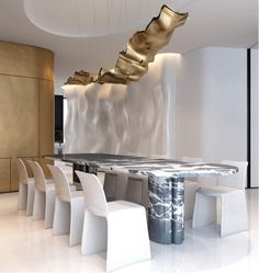 a modern dining room with white chairs and a marble table surrounded by gold leaf chandeliers