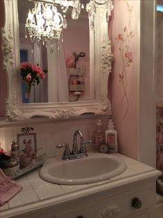 a white sink sitting under a mirror in a bathroom