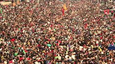 a large group of people standing around each other