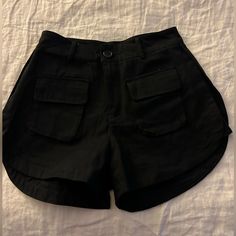 Black High Waisted Shorts. Never Worn. Small Pockets On Front And Back. Super Cute. Has Fabric Detailing On The Sides Also. Tag Says They Are A Large But That Is Definitely Wrong. I’m A Size 4 And They Only Just Barely Would Fit. Summer Black Shorts With Pockets, Black Summer Bottoms With Pockets, Black High-waist Shorts With Pockets, Black Bottoms With Pockets For Day Out, Black Short Summer Bottoms, Summer Black Short Bottoms, Trendy Black Shorts With Pockets, Trendy Black Shorts For Vacation, Fabric Detailing