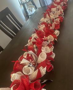 a long table with red and white bows on it