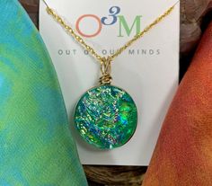 Because the beautiful emerald green colors of this glass remind us of Ireland, we have named this family of colors, "Limerick". This striking, handcrafted, circle dichroic glass pendant is created by combining layers of fusible and dichroic glass which produce a depth and brilliance of color that shifts and blends depending upon your angle of view. The glass is fired in the kiln at temperatures of up to 1800 degrees Fahrenheit and then shaped and ground before going back into the kiln for a fina Green Recycled Glass Jewelry For Healing, Healing Green Recycled Glass Jewelry, Healing Green Jewelry From Recycled Glass, Green Glass Jewelry Gift, Green Glass Jewelry As Gift, Green Glass Jewelry As A Gift, Artistic Green Glass Jewelry, Green Czech Glass Jewelry Gift, Green Round Glass Necklaces