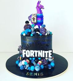 a cake decorated with blue, purple and black icing that says fortnite