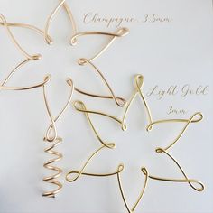 four different types of metal ornaments on a white surface with the words champagne 3 son and light gold snow