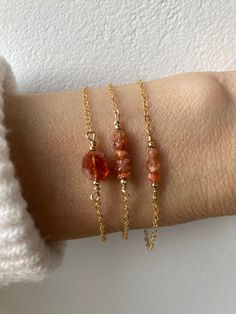 Beautiful crystals are combined with a delicate chain to create this lovely bracelet. Sunstone is said to harness the power of the sun to bring joy and light. D E T A I L S  *Made with AAA  sunstone gemstones in warm shades of orange and gold . Choose between a trio of beads, a bead bar of sunstone tyre beads or a sunstone nugget. * Sunstone is a feldspar crystal. It includes hematite and goethite which help it refract light and creates iridescence when viewed from different angles.  *Choose bet Gold And Beads Bracelet, Fall Inspired Jewelry, Chain And Bead Bracelet, Everyday Spiritual Orange Jewelry, Gemstone Bracelet Ideas, Bracelet Ideas Gold, Sun Bracelet, Sunstone Bracelet, Surf Jewelry