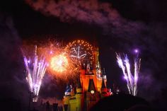 fireworks light up the night sky above a castle