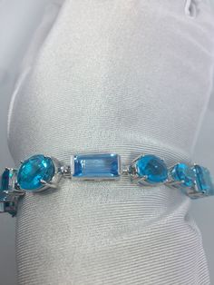 This Blue Topaz and Blue Quartz bracelet is very lively and bright. The stones are deep colors and different tones of blue The sterling silver is plated with rhodium to protect the bracelet from tarnish and give the appearance of white gold. 8 inches All jewelry is shipped in a nice gift box. Check out our over a THOUSAND great reviews Engraving is $4 per letter and is not always perfect depending on the piece. It can take a few days if the jeweler is busy. This is payable to Paypal Judithsltd@g Modern Blue Multi-stone Jewelry, Elegant Blue Multi-stone Bracelet, Elegant Blue Multi-stone Bracelets, Elegant Blue Aquamarine Bracelets, Blue Aquamarine Multi-stone Jewelry, Blue Multi-stone Aquamarine Jewelry, Luxury Blue Bracelets With Gemstone Accents, Blue Bracelets With Gemstone Accents As A Gift, Blue Bracelet With Gemstone Accents As Gift