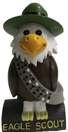 an eagle scout figurine wearing a green hat