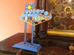 the welcome to fabulous n8 vegas sign is on display in front of a mirror