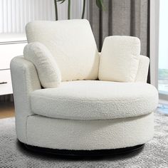 a white chair sitting on top of a rug