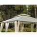 a white gazebo sitting on top of a grass covered field next to trees and bushes