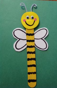 a paper craft with a yellow and black bee on it