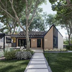 a modern house with a walkway leading to the front door and patio area, surrounded by trees