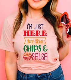 This "I'm Just Here For The Chips & Salsa" design is the perfect, fun Cinco De Mayo shirt for anyone that loves drinks and to celebrate! Fun Crew Neck Shirt With Funny Text, Pink Novelty Tops With Funny Print, Pink Tops With Funny Print, Fun Slogan Crew Neck Top, Pink Tops With Funny Text, Novelty Crew Neck Top With Funny Text, Novelty Screen Print Summer Tops, Novelty Screen Print Tops For Summer, Fun Pink Shirt With Funny Text