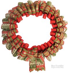 a christmas wreath with red and green ribbons