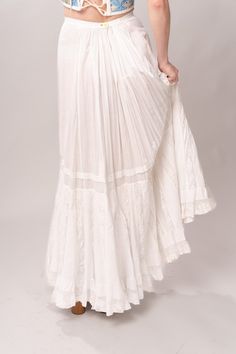 Stunning Edwardian 1910’s white cotton and lace maxi petticoat skirt. With a pretty flare silhouette, panel lace detail, and a button closure at waist. Good vintage condition, with normal wear and condition for its age. Some areas of visible mending a minor staining - see pictures. Best fits modern size XS/S Waist 26”Length 42” Featured top is the Blue Doll Quilt Corset from our friends at Psychic Outlaw. Model’s Measurements:Height 5’9”Chest 34”Waist 29”Hips 36.5” Daywear Long Lace Skirt, Cotton Long Skirt For Wedding, Cotton Tiered Wedding Skirt, Cotton Tiered Skirt For Wedding, White Lace Patchwork Long Skirt, Lace Trim Maxi Skirt For Wedding, Lace Trim Maxi Skirt, Flowy Wedding Maxi Skirt With Lace Trim, Fitted Long Petticoat With Lace Trim