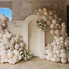 balloons and flowers are arranged in the shape of an arch