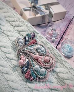 a close up of a cell phone case on a table with beads and other items