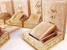 an assortment of gold jewelry boxes with intricate designs