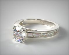 a white gold engagement ring with baguettes and channeled diamonds on the side