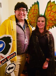 a man and woman standing next to each other wearing costumes that look like they're from the simpsons