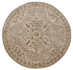 a round rug with an ornate design on the center and bottom, in beige tones