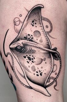 a manta ray fish tattoo on the thigh