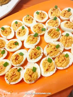 an orange platter filled with deviled eggs