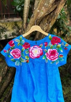 ❤ The blue hand embroidered dress is soft, skin friendly, breezy and comfortable.  ❤ Item description: - It's a lovely dress like a mini flower garden with colourful embroidered rose flowers motifs. - Material: linen fabric, button, hand embroidery. - Environmentally friendly. - This dress is very useful, go with any outfit, that can be used to go to school, go out, go shopping.    It is a perfect gift for yourself or your beloved.  ❤ Care instructions:      The best way to wash embroidery cloth is to put it in soapy water (with a mild detergent and cold water at 86 ºF/30oС) for 20 minutes. Try to not wash the item with other clothing that might cause damage, such as zippers, buttons or different colors. You wash it by hand, and if you have dirty patches on your garment, you can gently rub Light Blue Floral Embroidery Dress For Summer, Light Blue Floral Embroidered Dress For Summer, Light Blue Floral Embroidered Summer Dresses, Light Blue Summer Dresses With Floral Embroidery, Summer Light Blue Dress With Floral Embroidery, Traditional Light Blue Summer Dress, Summer Blue Embroidered Floral Print Dress, Blue Floral Print Embroidered Summer Dress, Blue Folk Dress For Spring