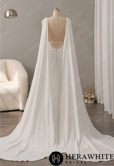 the back of a wedding dress with a cape on it's neck and shoulders