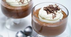 two glasses filled with chocolate pudding and whipped cream