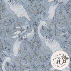 a blue and white wallpaper with two birds on it's back side, in front of an ornate design