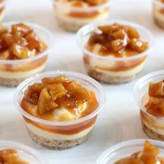 small desserts are arranged in plastic cups on a table