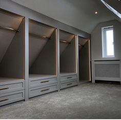 an empty room with some drawers and lights