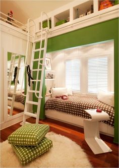 a bedroom with a bunk bed and ladder to the upper level, next to a green wall