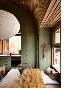 a wooden table sitting in the middle of a kitchen