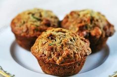 three muffins sitting on top of a white plate