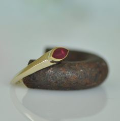 "This is a special red Ruby wedding ring.  A unique fine hand made gold ring. Beautiful red marquise Ruby sets on the center of 14k solid gold ring. The Ruby sets in an upper central bezel that made a specially for this stone. The angle of the bezel go all around the ring from side to side. This fine jewelry ring will make you feel pretty and special. Dimensions: *  14k gold ring * Marquise Ruby: 8m\"m * 4 m\"m  For other rings in my shop you can look here: https://www.etsy.com/il-en/shop/malkaravinajewelry?section_id=13724109&ref=shopsection_leftnav_2   A similar ring of main in \"lucky magazine\"  http://www.luckymag.com/shopping/2013/06/etsy-engagement-rings_slideshow_item16_17 My jewelry shop: https://www.etsy.com/il-en/shop/malkaravinajewelry?ref=seller-platform-mcnav" Red Marquise 14k Gold Jewelry, Unique Yellow Gold Ruby Promise Ring, Red 14k Gold Marquise Ring, Red Ruby Ring With Bezel Setting For Promise, Red Marquise 14k Gold Ring, Red Ruby Promise Ring With Bezel Setting, Formal Red Stackable Rings In 14k Gold, Red Ruby Ring In 14k Gold For Promise, Red Ruby Ring In 14k Gold With Bezel Setting