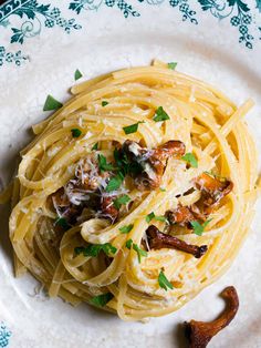 pasta with mushrooms and parmesan cheese on a plate