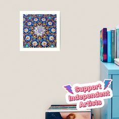 there is a blue dresser with books on it and a sticker that says support independent artists