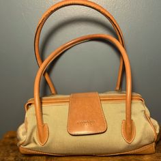 Leonard Paris Frame Handbag In Tan/Beige And Brown In Great Condition Doctor Style Framed Bag Beige Shoulder Bag With Leather Trim For On-the-go, Classic Beige Pouch Satchel, Cream Shoulder Bag With Leather Trim And Top Handle, Khaki Top Handle Travel Bag, Khaki Top Handle Bag With Handles, Elegant On-the-go Satchel With Leather Trim, Khaki Top Handle Shoulder Bag For Travel, Luxury Khaki Shoulder Bag For Travel, Light Brown Leather Handle Shoulder Bag For Travel