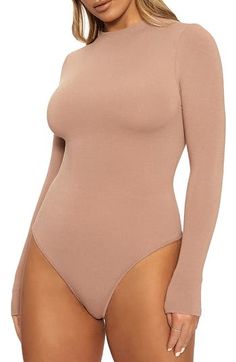 Start your look off right with this thong bodysuit that fits like a second skin and is shaped with a high neckline and extra-long sleeves. Exclusive retailer Snap closure Funnel neck Long sleeves Lined 95% viscose, 5% spandex Hand wash, line dry Made in the USA or imported Women's Clothing Naked Wardrobe, Extra Long Sleeves, Simple Chic, Women's Shapewear, Sheer Sleeves, Funnel Neck, Womens Bodysuit, High Neckline, Second Skin